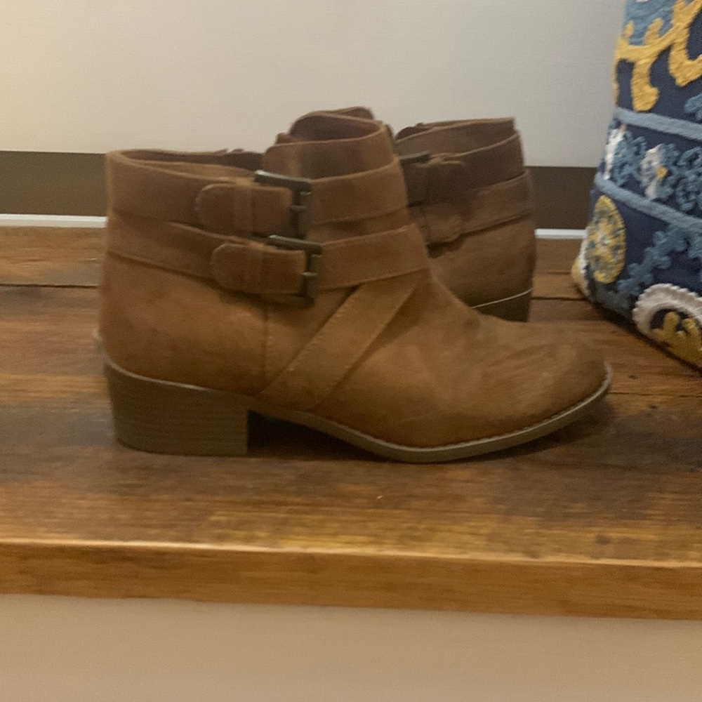 light brown booties with zipper and buckle on side.